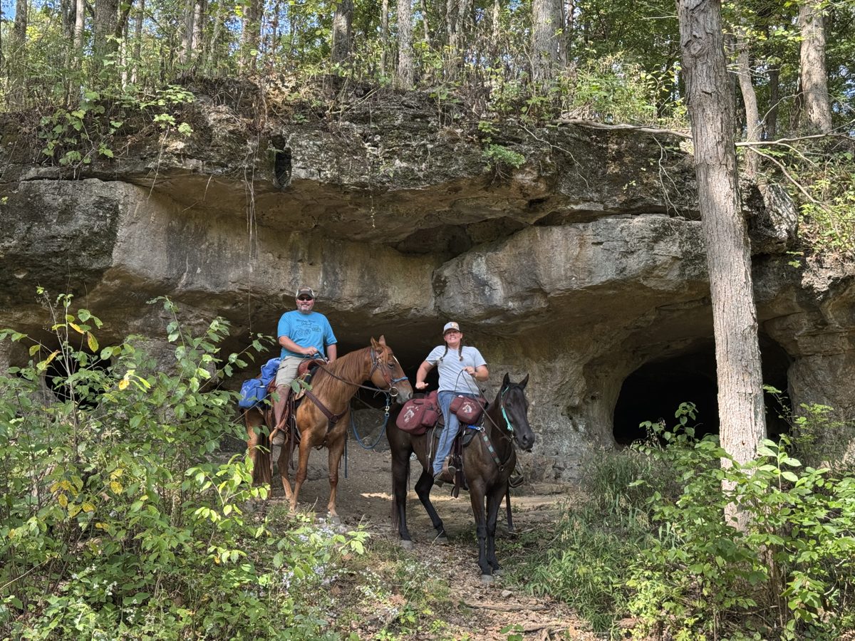 Riders by a bluff cave